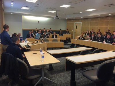 Photo of full classroom of students at a Penn State sports business club meeting in the business building